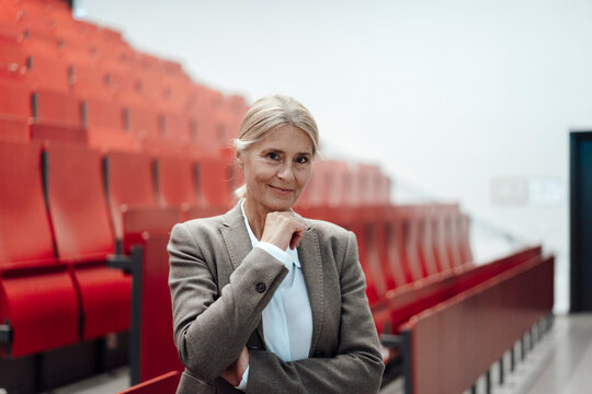 Businesswoman with hand on chin at office auditorium