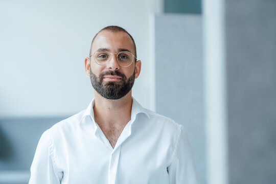 Smiling freelancer wearing eyeglasses at home office