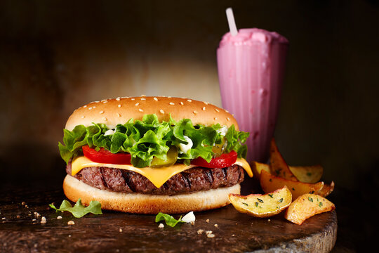 Cheeseburger, strawberry milkshake and potatoe wedges