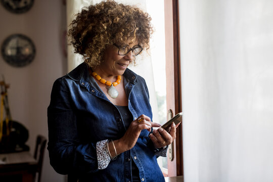 Woman using phablet by the window
