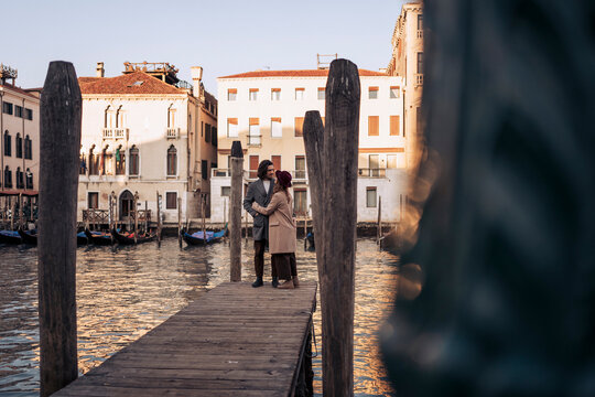Young couple on a jetty at the Canal Grande in Venice, Italy
