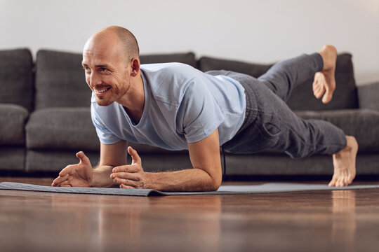 Man doing gymnastics at home