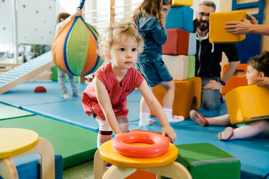 Little girl playing in gym room of a kindergarten
