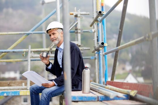 Architect having a break on scaffolding on a construction site