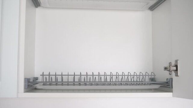 Kitchen cabinet dish rack pulled out for cleaning