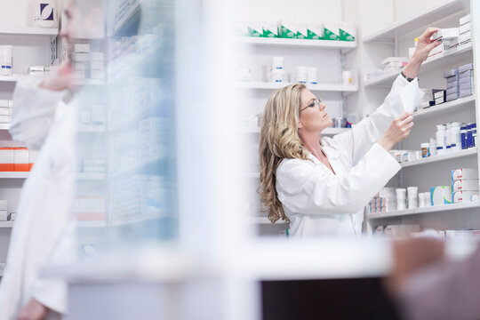 Pharmacist helping clients at pharmacy dispensary