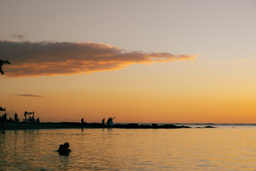 Fototapeta premium Group of people at sunset in Mauritius