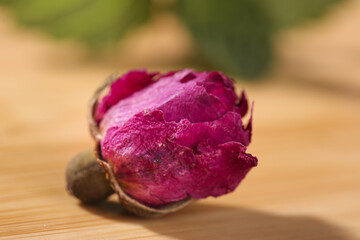 Obraz premium Dried Rose Petals from Yunnan China in Wooden Spoon for Traditional Herbal Tea