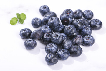 Fresh Blueberries with Mint Leaf - Organic Superfood Berries on White Background © NgoThi
