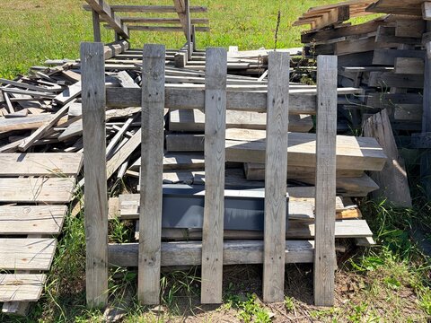 A large pile of wooden construction debris in an open area