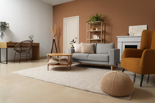 Interior of stylish living room with sofa, armchair and soft carpet