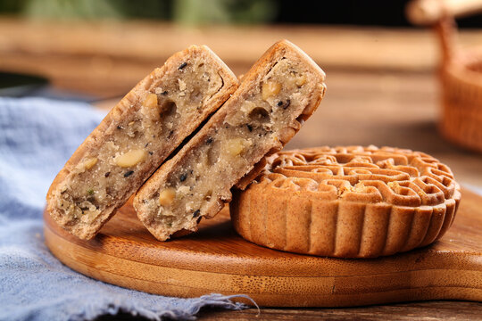 Traditional Buckwheat Mooncake Pastry with Nuts on Wooden Board