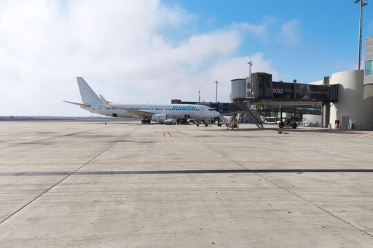 Larnaca, Cyprus, June 25, 2026. Passenger aircraft parked at an airport gate with jet bridge and ground service equipment, commercial aviation, air travel and modern airport operations.