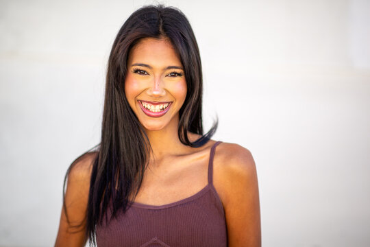 Smiling woman portrait against neutral background