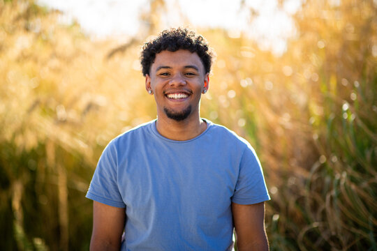 Smiling young man portrait in warm sunset light