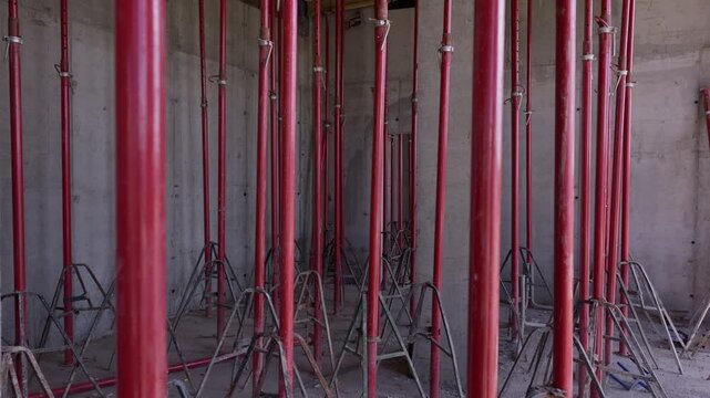 Temporary steel shoring props supporting concrete formwork