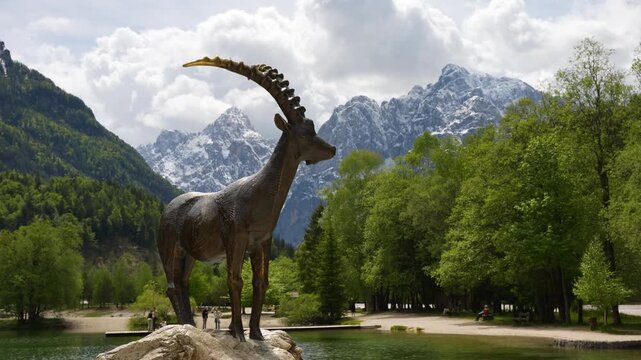 Discover the famous bronze Goldhorn statue standing proudly by the scenic shores of Lake Jasna.