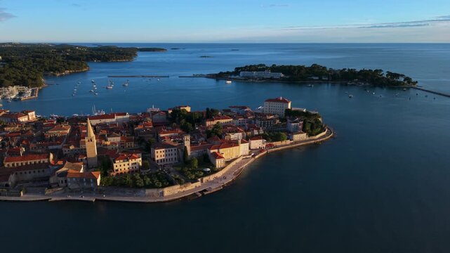 Old town of Porec, Croatia, with its iconic church tower rising above the roofs. Majestic aerial view