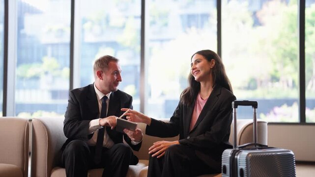 Business partner offers pen to client for signing contract on digital tablet after successful discussion. Modern paperless agreement, electronic signature, trust and professional corporate partnership
