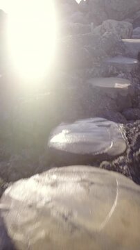 Person POV Walking over stone path at sea