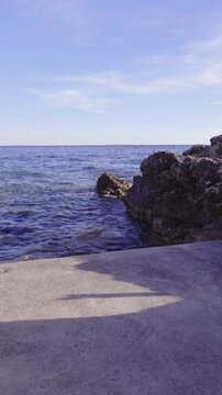 Stone beach with waving sea