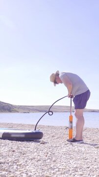 Pumping sup board on beach