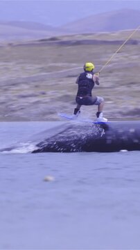 Tracking wakeboarder making stunts on sea