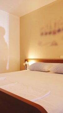 Person shadow on wall in bedroom