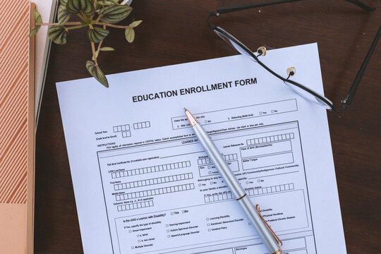 Education Enrollment Form With Pen Eyeglasses and Office Desk for School Admission Student Registration and Academic Records