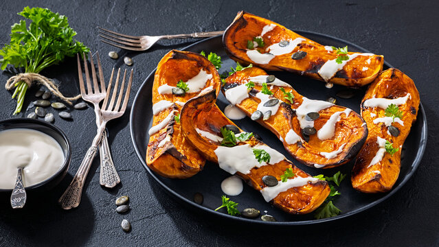 Baked butternut squash halves with yogurt sauce