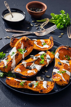 Baked butternut squash halves with yogurt sauce