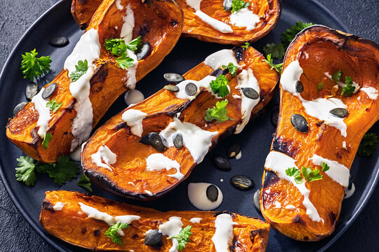 Baked butternut squash halves with yogurt sauce