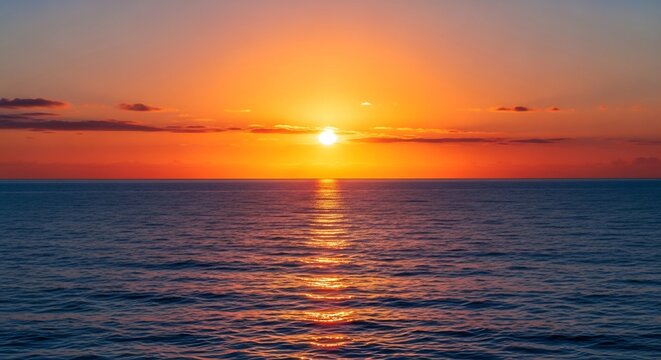 Golden sun setting directly over the horizon of a calm ocean surface.
