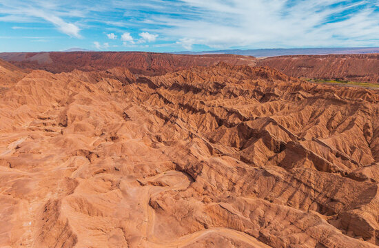 Aerial view of the rugged rock formations and deep canyons of the Devil's Throat Viewpoint in the arid desert landscape in Catarpe, Antofagasta, Chile.