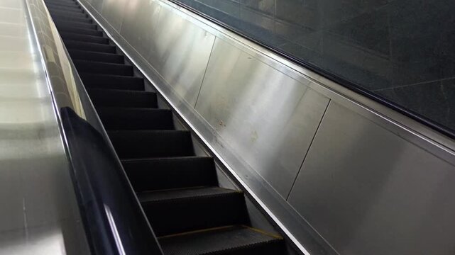 Low Angle View of Empty Mechanical Escalator Stairs Moving Upwards