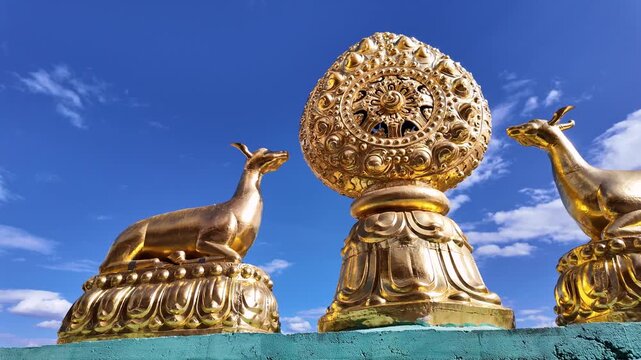 Yunnan, China : Panoramic footage of wheel of Dharma and the 2 deer, a symbol of Tibetan Buddhism in the Sumtseling Monastery in Shangri-La in Yunnan, China under blue sky