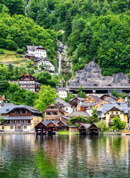 The beautiful village of Hallstatt and a waterfall in  Austria. This is the second most visited place in Austria after Vienna. 