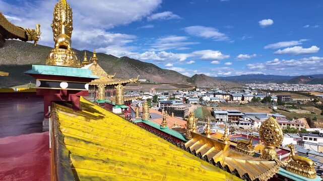 Shangri La, China : Tilt down footage from the prayer hall roof of the tibetan Buddhism Songzanlin Monastery overlooking the Shangri-La landscape in the mountains of Yunnan, China