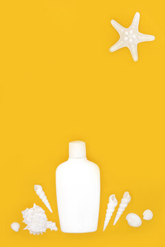 Summer suntan lotion bottle on yellow background. Fun holiday abstract design, starfish sun, white sea shells. Symbols for the vacation season. Greeting card.