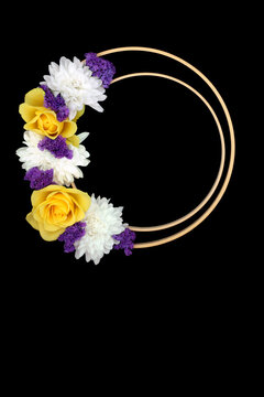 Yellow rose chrysanthemum flower abstract wreath logo decoration design on black background with two wooden circular  frames. Floral garland for greeting card 
