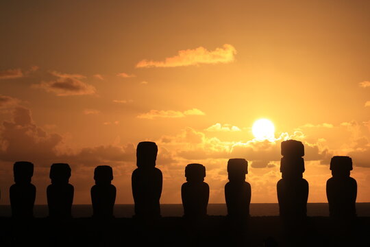 Sunrise at Ahu Tongariki. Because this platform faces east, the sun rises directly behind the 15 moai statues during the summer solstice, creating these stunning silhouettes against the Pacific Ocean.