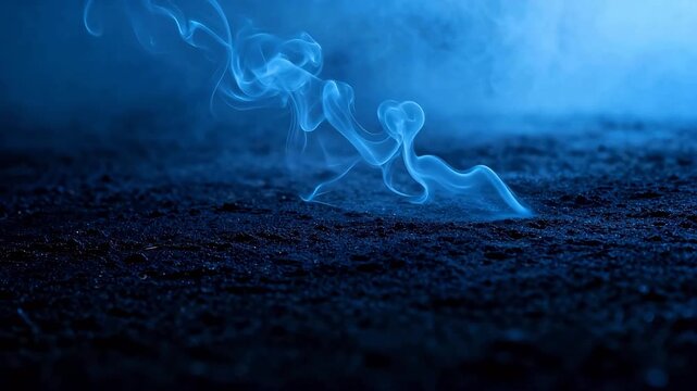 Blue smoke rising from dark ground