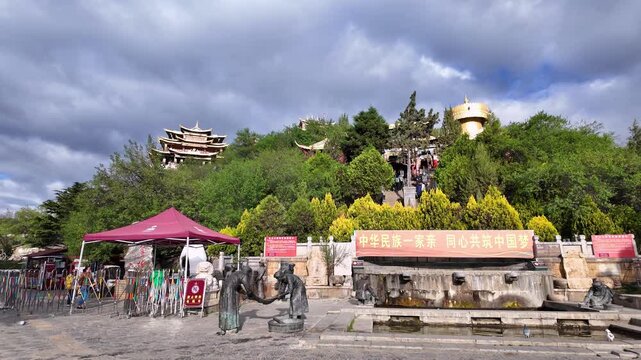 Yunnan, China: Panoramic footage of morning situation in the famous Guishan Park in Shangri-La ancient old town in Yunnan in China with Tibetan Buddhism temples and the giant prayer wheel in the backg