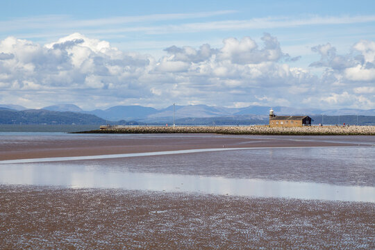 The Stone Jetty Breakwater in Morcambe Bay in the North West of Englandl ooking across the sand and mudflats