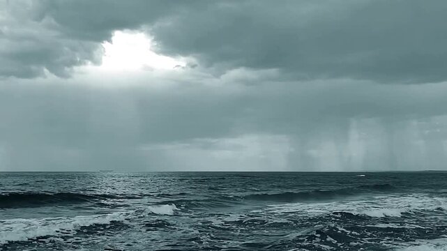 Stunning 4K shot of Storm Clouds and Rain Curtains Over an Ocean Horizon. Monsoon season and hot cloudy weather, Heavy rainfall expectation and storm.