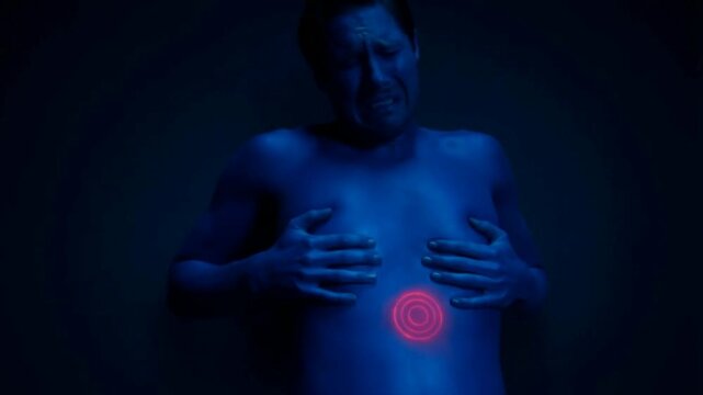 ​A man grimacing in severe abdominal pain, highlighted by a pulsing red target indicator on his stomach.