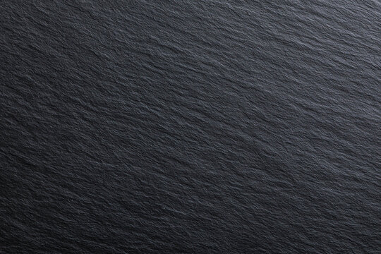 top view close up of raw black slate stone texture with diagonal natural grain