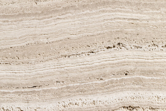 Natural beige travertine marble stone surface texture with detailed parallel vein patterns