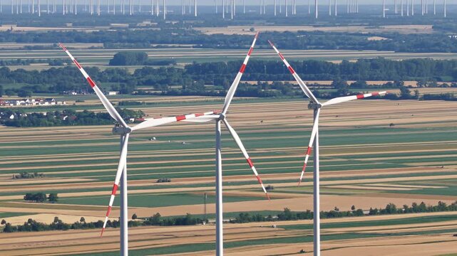 Wind turbines across agricultural fields in summer, Austrian Burgenland