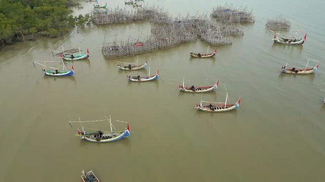 Local Boats Floating And Bamboo Fishing Platforms Galis Area Madura Island Indonesia Drone Shot 4K 60FPS